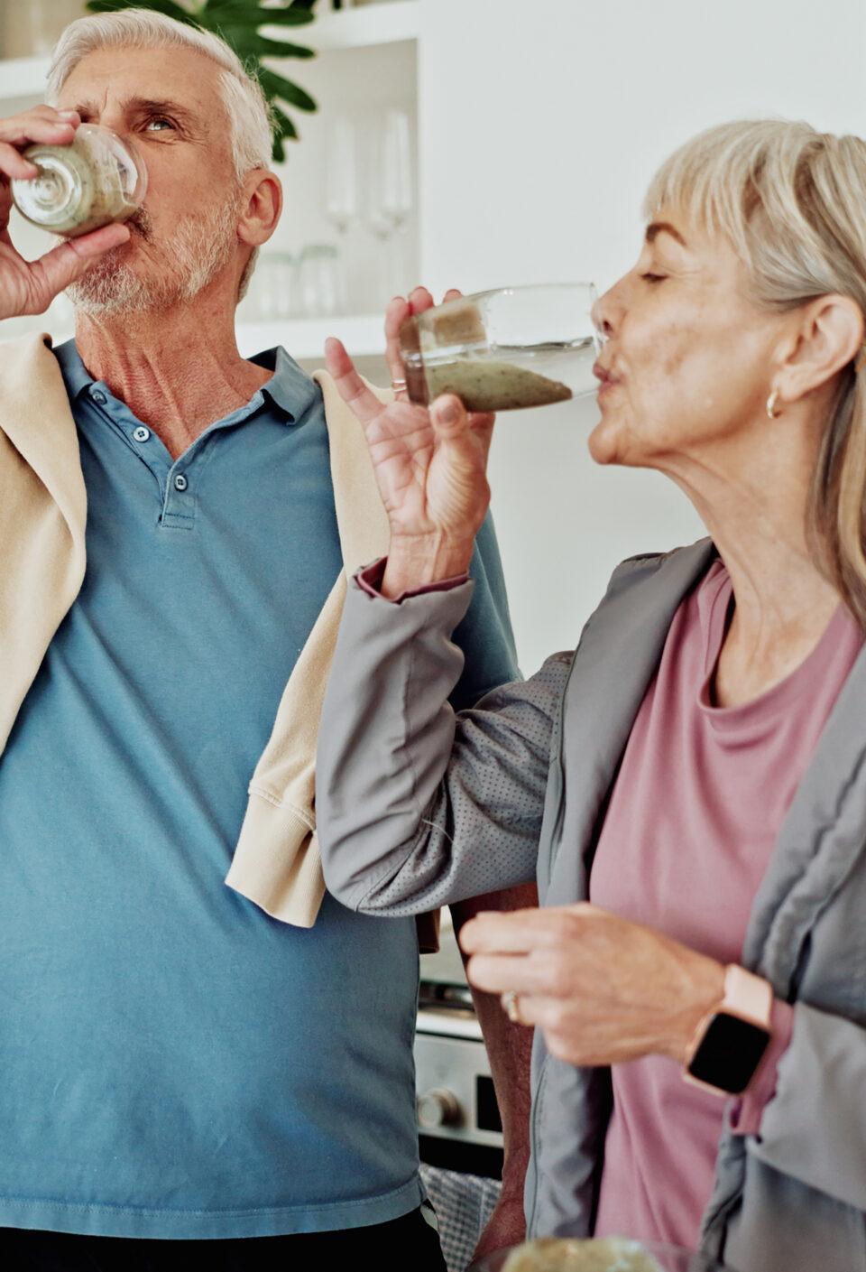 Exercise, drinking smoothie and old couple in kitchen for nutrition, breakfast and supplements. Fitness, mature man and woman in home, health and protein shake for wellness, diet plan and minerals Exercise, drinking smoothie and old couple in kitchen for nutrition, breakfast and supplements. Fitness, mature man and woman in home, health and protein shake for wellness, diet plan and minerals