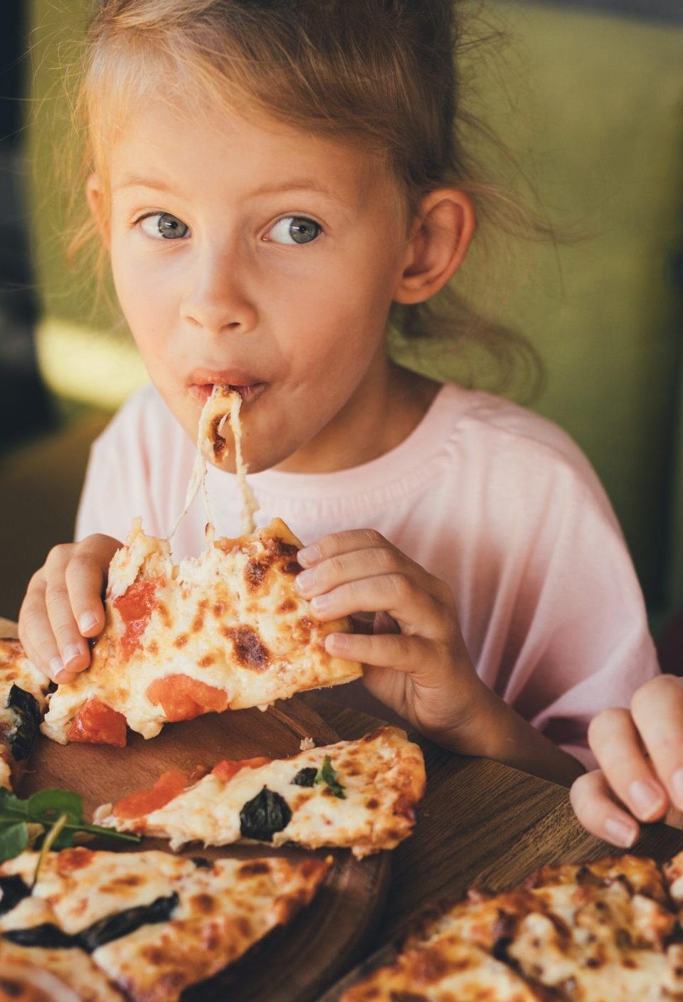 Mother and daughter eat pizza in a cafe. Mother and daughter eat pizza in a cafe.